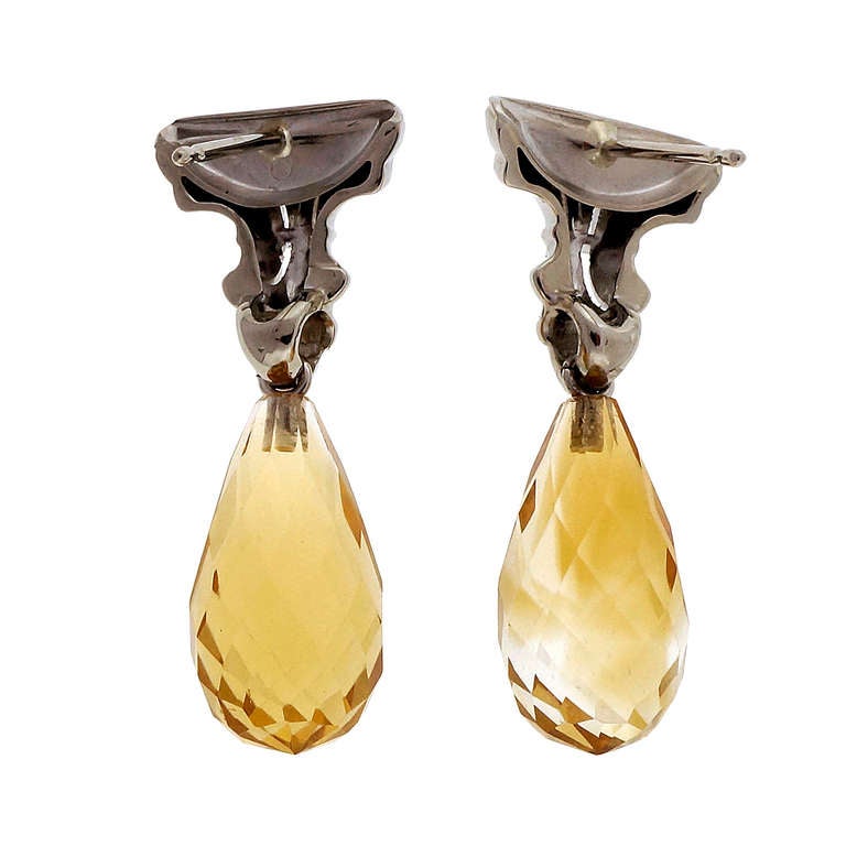 Mid century 1950 natural Citrine Briolette dangle earrings with bright medium golden yellow Citrine dangles and Fleur de Lis white gold diamond tops. Looks great on the ear.

14k White gold 
Two yellow Briolette Citrines, approx. total weight
