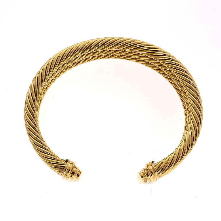 Classic David Yurman retired 18k 3 row 5mm cable cuff bracelet.

42.5 grams
Stamped: 18k 18k Yellow Gold
Tested: 18k
Hallmark: D Yurman
3 rows of 5mm cable
width: 15mm or .59 inch
Inside dimensions: 2.19 x 1.65 inches
Fits a standard 7  to