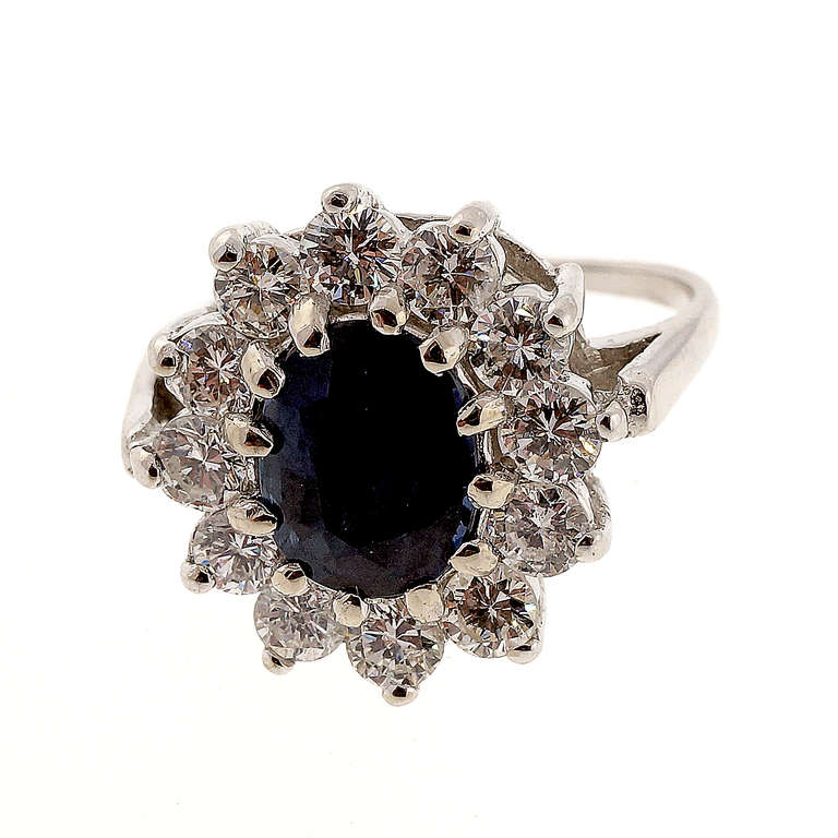 Top gem cornflower blue oval Sapphire in a simple oval cluster with bright white round diamonds, GIA certified in the setting as natural no heat no enhancements. Looks great on the hand. Circa 1960.

1 oval fine cornflower blue Sapphire, approx.