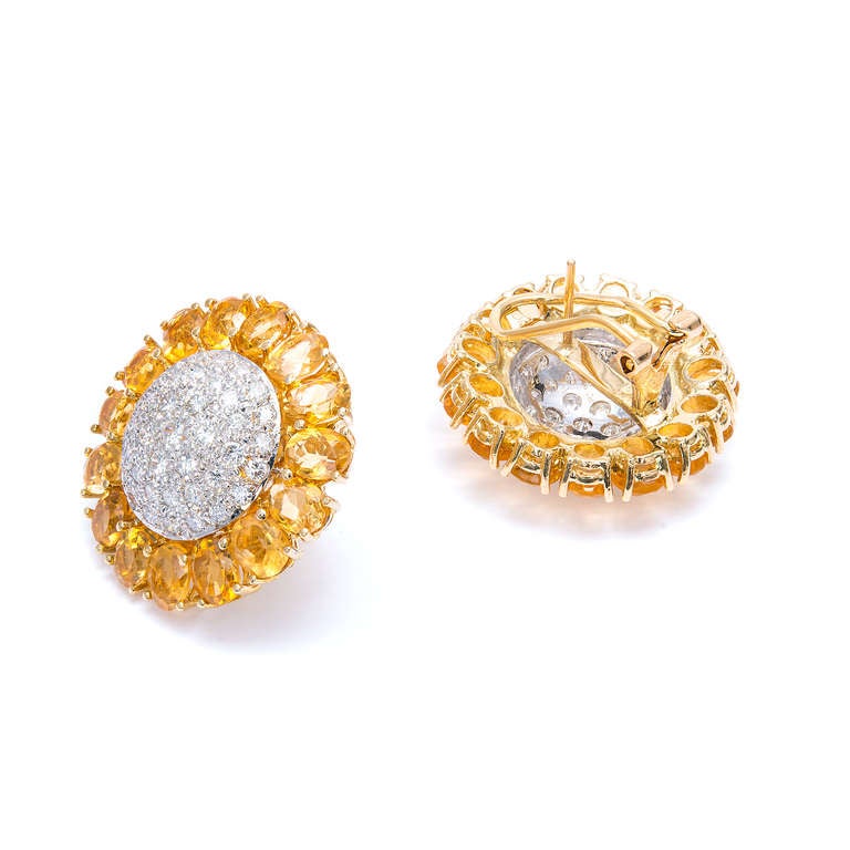 1950's round domed button style earrings with golden yellow Citrines
surrounding a white gold dome of Pave set white diamonds. 

18k Yellow and white gold
Approx. 52 round diamonds, approx. total weight 1.15cts, H, SI 
30 oval golden yellow