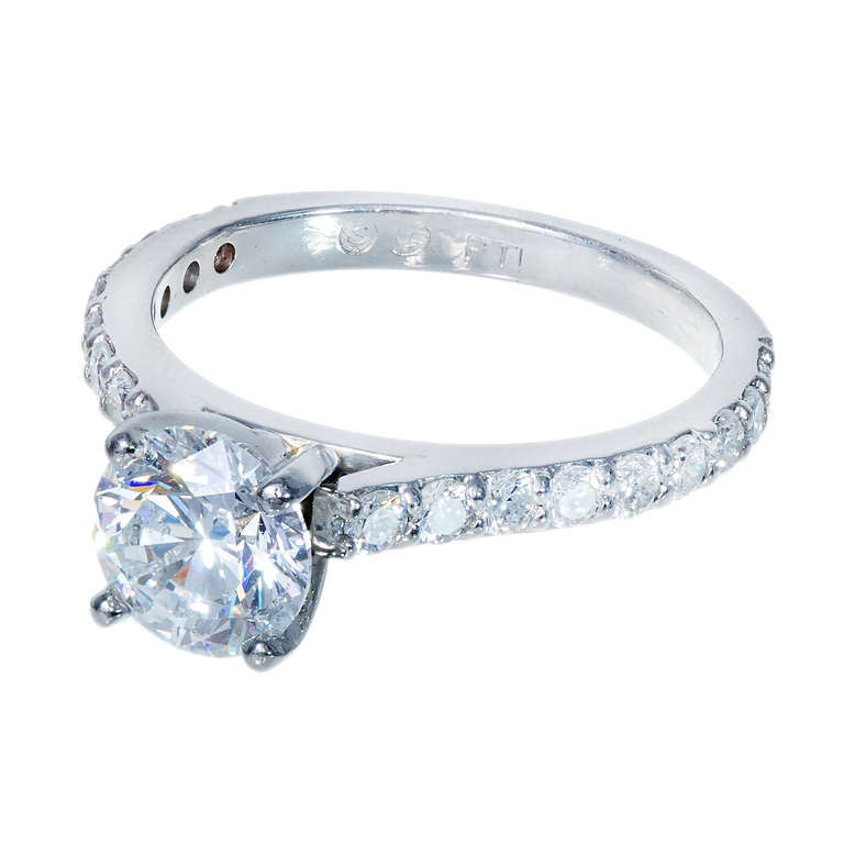 Simple solitaire diamond engagement ring. Ideal cut excellent cut center stone in a simple common prong Platinum setting that allows a wedding band to set flush next to it. Full cut diamonds on each side of shank. GIA Certified. 

1 round Ideal