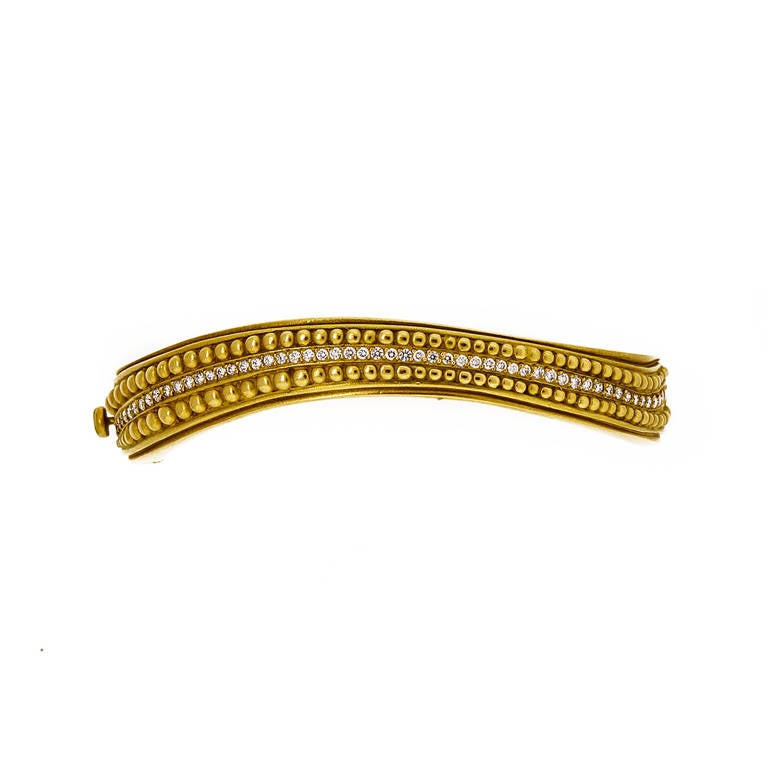 Nice Kieselstein Cord solid 18k gold Caviar bangle bracelet. Double side lock safeties. Safe and secure. Looks great on the wrist.

18k Yellow gold
56 full cut diamonds, approx. total weight .75cts, G, VS
Width: 13 to 8.5mm
Depth: 5.38mm
53.0