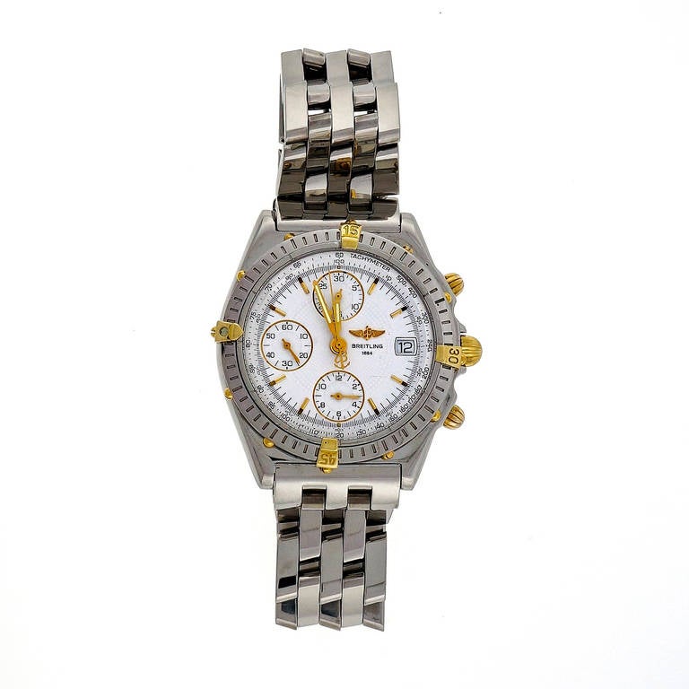 Breitling stainless steel Chronomat automatic chronograph wristwatch with date and gold accents and buttons. Stainless steel bracelet.

Stainless Steel 
Bracelet length: 7 7/8 inches 
Top to bottom: 45mm 
Width without crown: 38mm 
Width with