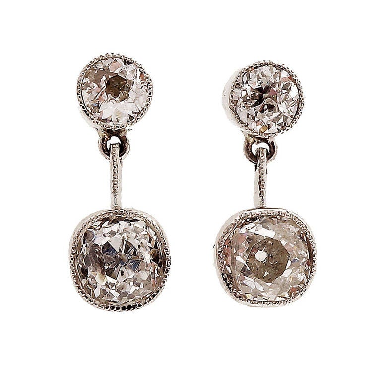 Late Victorian handmade diamond platinum dangle earrings. circa 1900-1910. Handmade dangle mil-grain bezels.

2 old mine brilliant cut diamonds, approx. total weight .37cts, G-H, SI2 - I1, EGL certificate #US68601101J
1 old mine brilliant cut