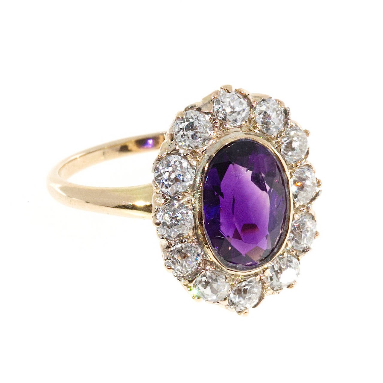1890's Victorian handmade ring with old mine cut sparkly diamonds surrounding a bright reddish purple gem Amethyst.

1 oval reddish purple natural Amethyst 10 x 7mm, approx. total weight 2.40ct
12 old European cut diamonds, .10ct each, approx.