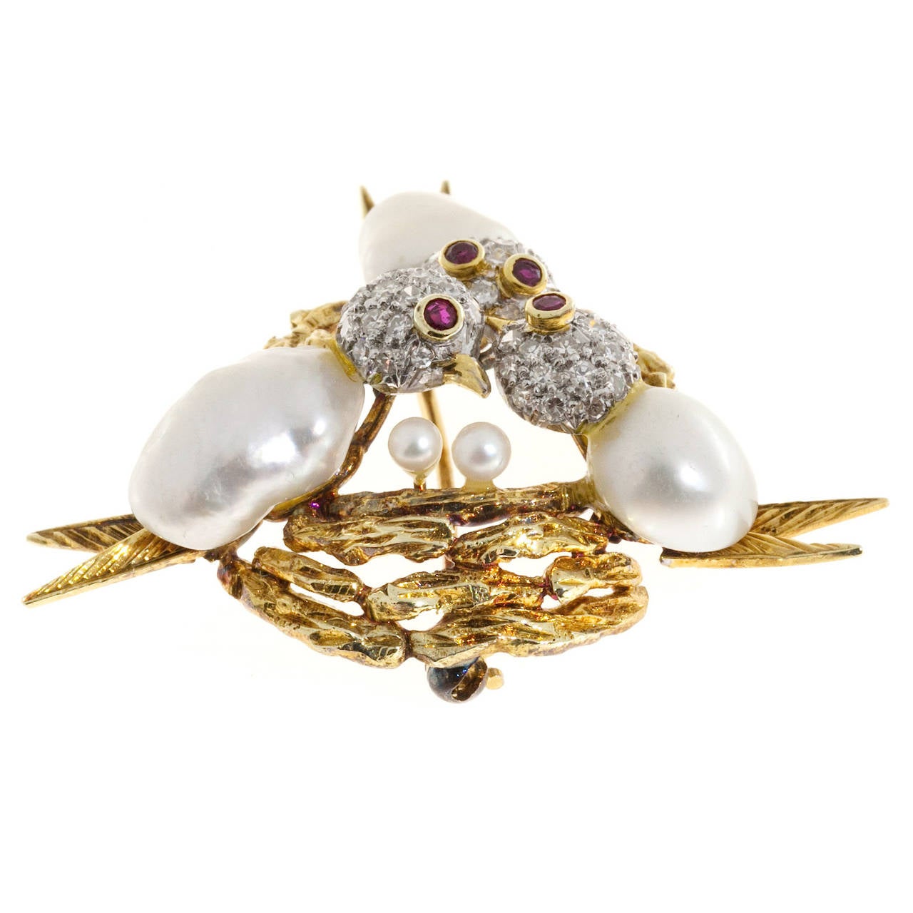 Trio- Three birds nest brooch. circa 1960's with 3 3-D birds with pearl bodies, diamond heads and ruby eyes, set in a 14k yellow gold nest. 

45 single cut diamonds, approx. total weight .30cts, F, VS
2 2mm round pearls
4 1.5mm genuine Ruby eyes
3