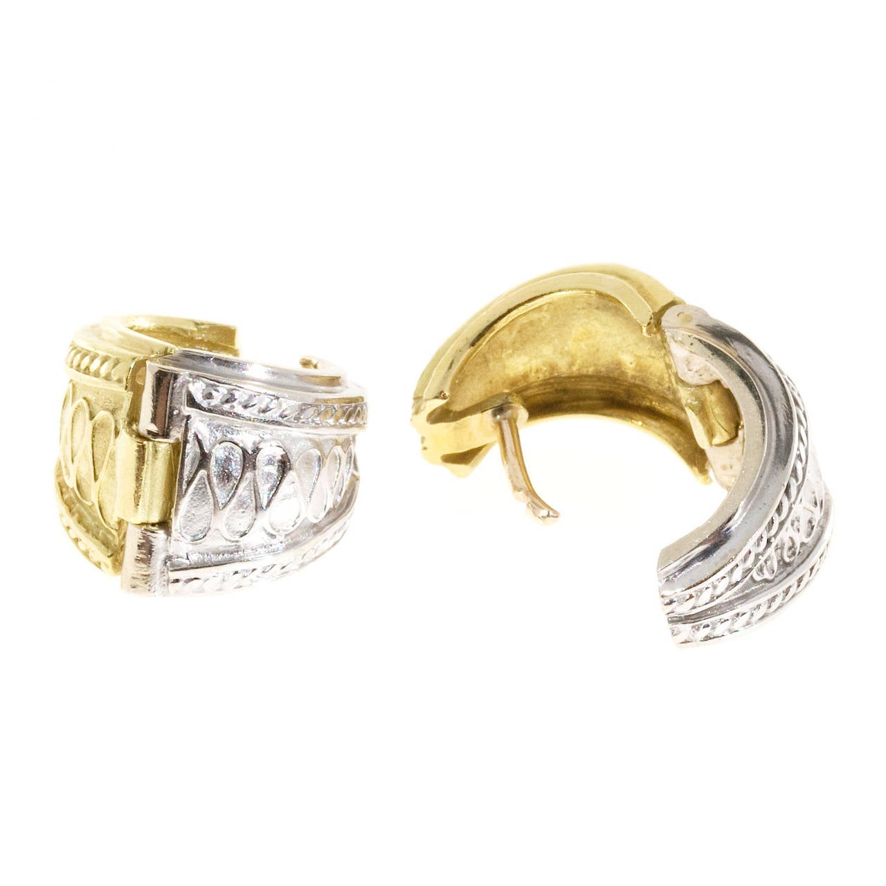 Yellow and white gold Seidengang huggie style earrings. Hinged at the bottom with fixed post.

18k yellow and white gold
Tested and stamped: 18k
Hallmark: SG
9.8 grams
Top to bottom: 14.58mm or .57 inch
Width: 11.41mm or .45 inch
Depth: