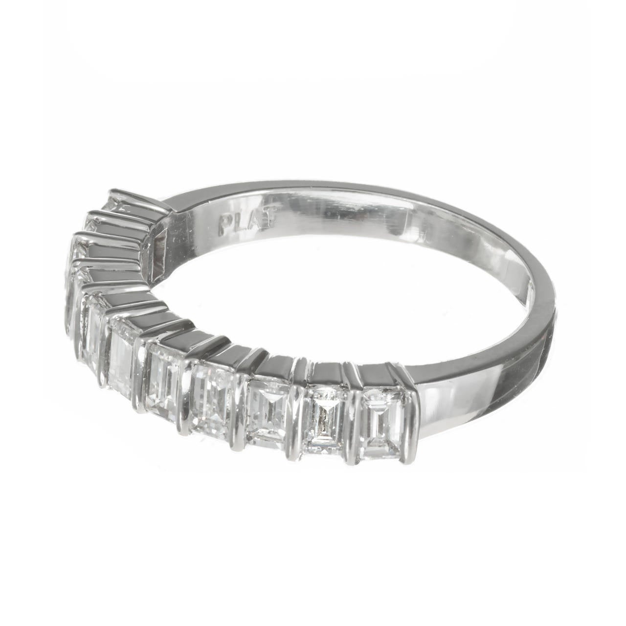 Exceptional 1960’s bar set 11 Emerald cut diamond wedding ring. Exceptional condition, shows little to no wear. Deep old style stamps.

11 Emerald cut diamonds, approx. total weight 1.00cts, F, VS1
Platinum
4.4 grams
Tested: Platinum
Stamped: