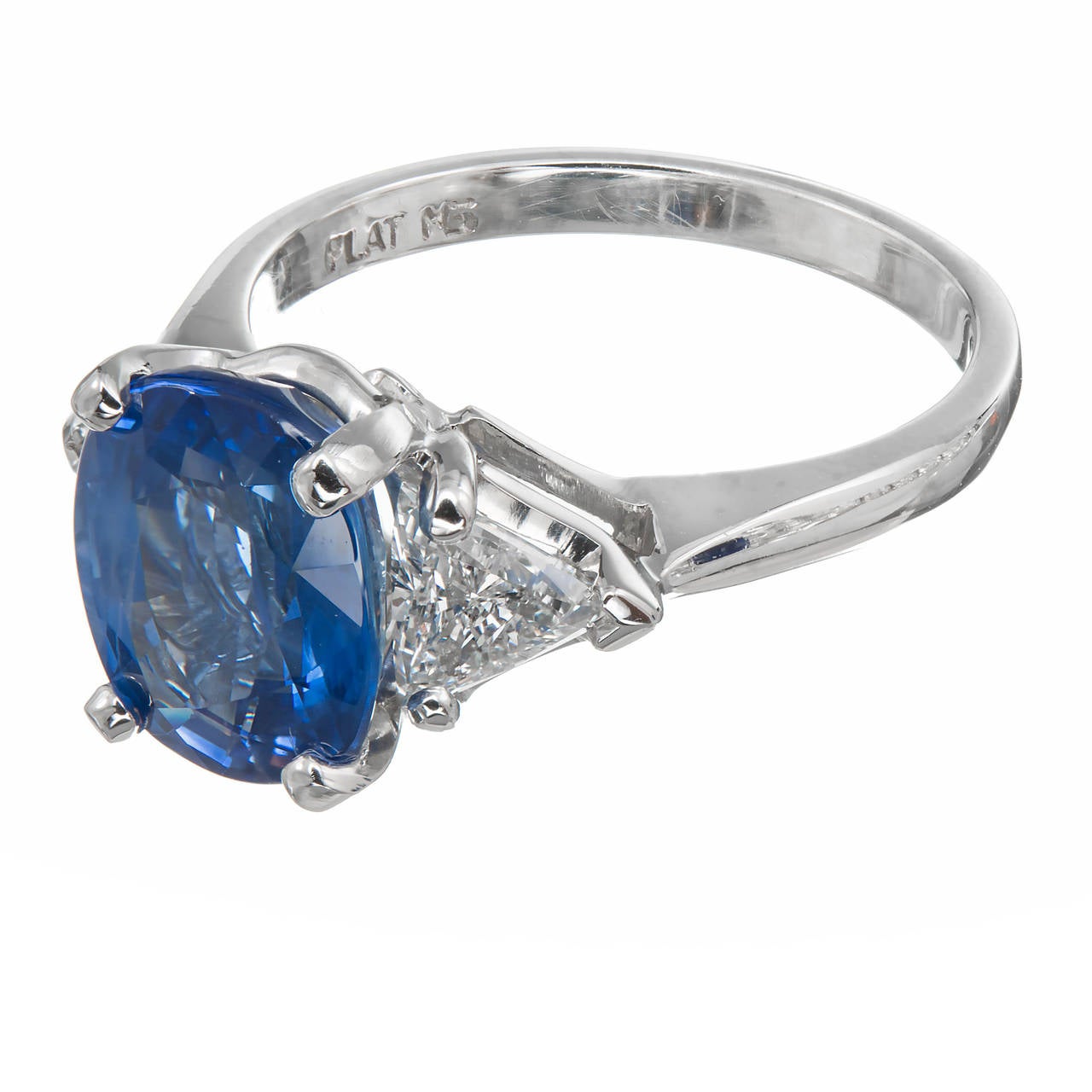 Strikingly bright and beautiful pure cornflower blue natural simple heat only certified Sapphire ring with very bright high color trilliant sides. The center stone is one of those rare Sapphires that is bright top to bottom and side to side all