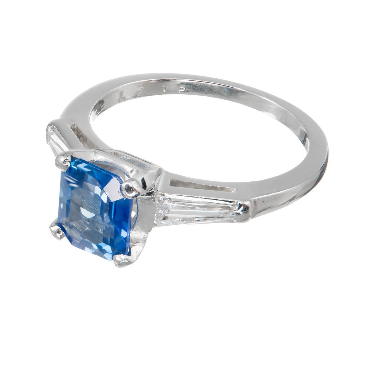 Classic style with fine diamond baguettes. Center stone removed for certificate. Rare pure bright blue color.

1 Emerald cut bright cornflower blue Sapphire, approx. total weight 1.39cts, VS, 7.09 x 5.79 x 3.32mm, natural color and simple heat