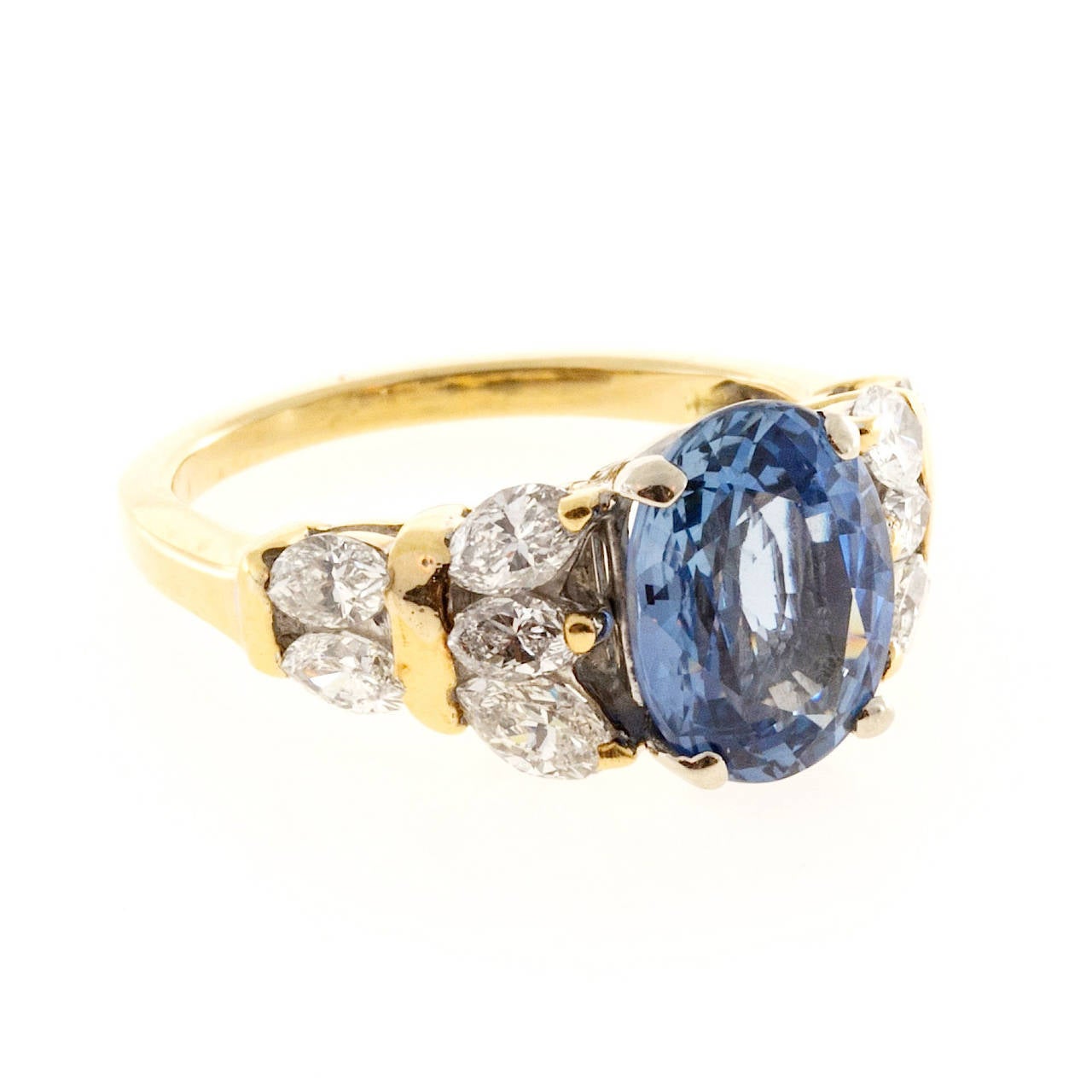 3.11ct fine bright blue Sapphire of medium periwinkle color tone in a very unusual yellow gold ring with Marquise diamond sides.

1 Original certified 3.11ct oval natural periwinkle blue Sapphire simple low level heat only, 9.97 x 7.61 x 4.62,