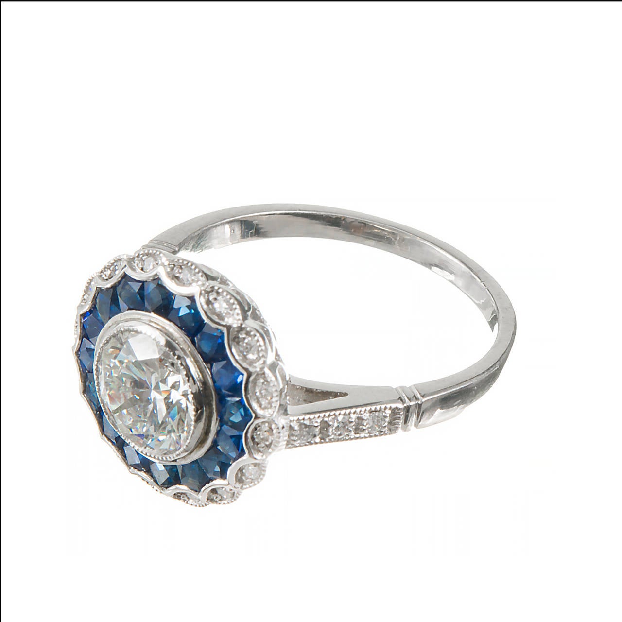 Platinum ring with genuine calibre Sapphires and small old cut diamonds with an early Ideal cut center diamond extra sparkly GIA certified I, VS, 60.6% depth and 61% table.. A real sparkler.

1 round diamond, approx. total weight 1.21cts, I, VS1,