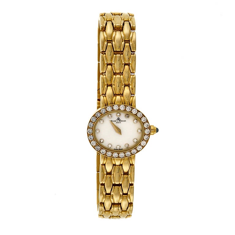 Baume & Mercier Lady's 18k Yellow Gold and Diamond Wristwatch, circa 2000s, with 39 full cut diamonds F, VS, .75 cts total in the bezel and the mother-of-pearl dial

18k yellow gold
Bracelet length: 6 7/8 inches with six removable links
Width:
