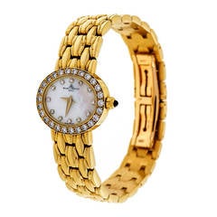 Baume & Montre-bracelet en or jaune et diamants pour femme Mercier circa 2000s