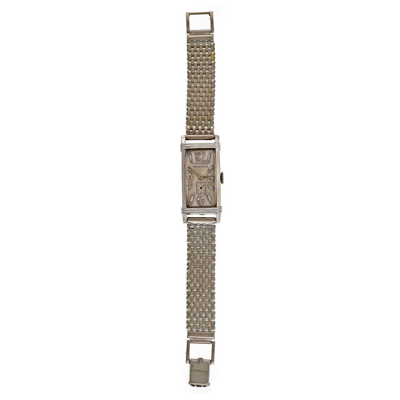 Wonderful 1935 to 1940 Art Deco Platinum Longines classic elongated rectangular watch with round and baguette diamond markers and sub second hand. Longines was a recognized house brand watch maker used by Tiffany during this period. Dial may be an