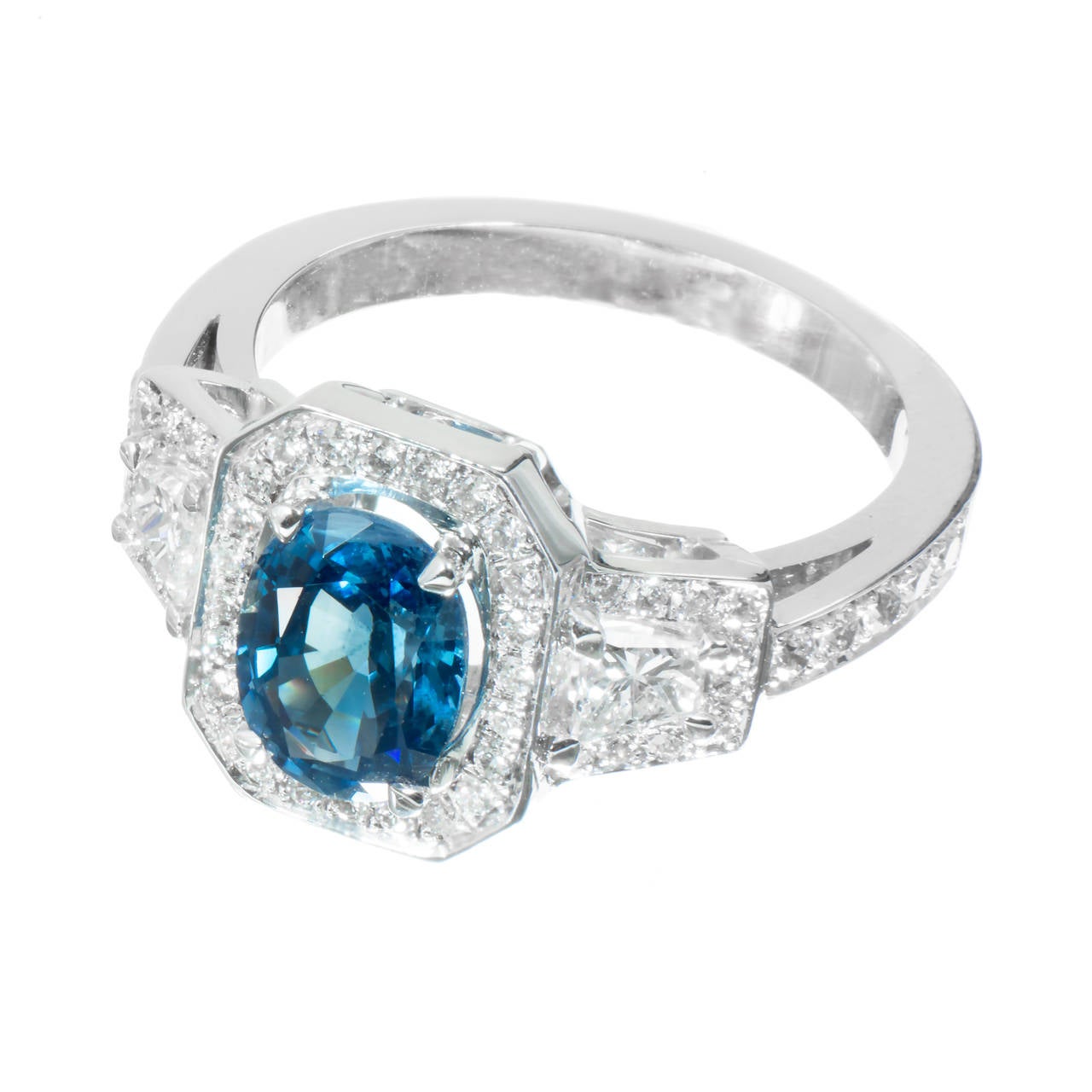 Oval Sapphire medium blue translucent Ceylon type color 1.62ct GIA certified natural color simple heat. Paired with trapezoid diamonds in a custom made 18k white gold triple halo setting from the Peter Suchy Workshop. 

1 oval blue Sapphire, approx.