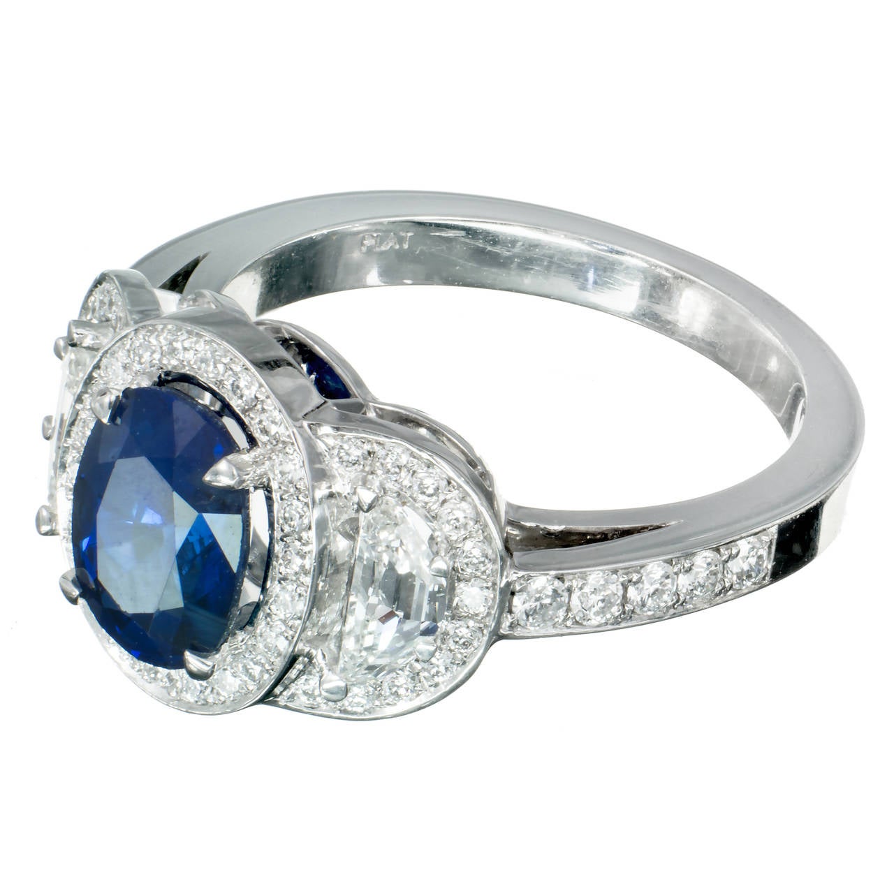 Blue oval Sapphire 1.89cts, GIA certified natural corundum simple heat. The ring was designed with old step cut half-moon diamonds to go with the beautiful estate Sapphire in a triple halo platinum setting from Peter Suchy Designs. 

1 oval top gem
