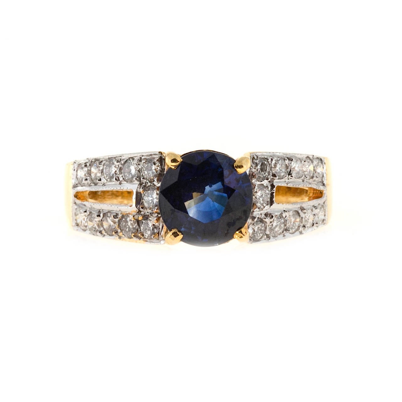 Beautiful estate handmade ring in 20k yellow gold with white gold shoulders pave set with E to F color, VS clarity diamonds.  The center contains a top vivid blue genuine well cut round sapphire, as bright blue as anything in my store.

1 round