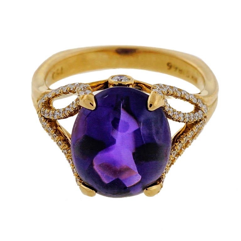 Ultra rare untreated reddish purple cabochon top Amethyst from the Richard Krementz live mounted into a top quality 18k yellow gold ring by Krementz and Co.

1 oval gem purple buff top Amethyst, approx. total weight 4.50cts, VVS
75 Ideal full cut