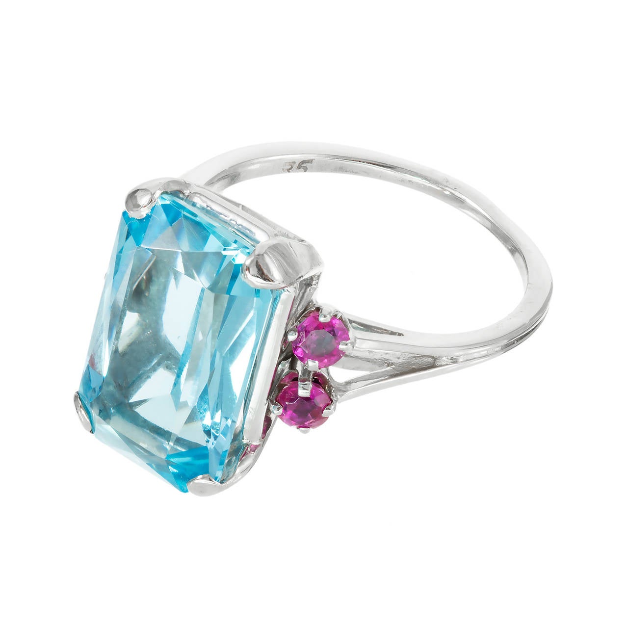 1950  gem blue untreated natural 6.03ct Aqua in a simple white gold ring with bright red Rubies, well-polished. Excellent color combinations.

1 Emerald cut bright gem blue Aquamarine, approx. total weight 6.03cts, VS, 13.98 x 9.19 x 5.42mm
4