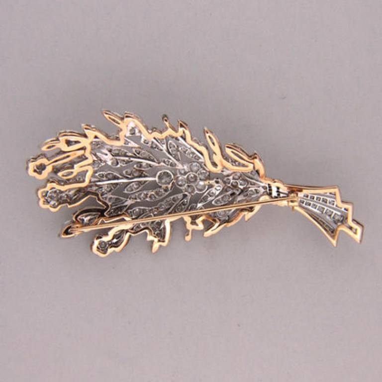 Circa 1910 wonderful solid Platinum flower pin with 14k pink gold stem and rear frame. Intricate bead work. Bright sparkly old mine cut diamonds. Early 1900's garland style design. Truly one of the best flower pins we have ever seen.

212 round