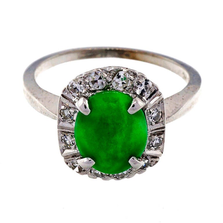 Fine natural untreated Jadeite Jade approaching Imperial color, slightly mottled, well-polished bright green, circa 1950-1960 in a nice white gold ring.

1 oval bright green Jadeite Jade 9.97 x 7.78 x 2.22mm, translucent, natural and no