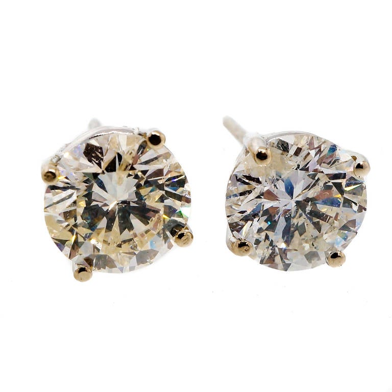 Vintage diamond stud earrings circa 1950. Simple basket settings with excellent cut near Ideal proportion extra sparkly diamonds with loads of brilliance. Flaws are not readily visible to the eye. Face up color white and well matched because of blue