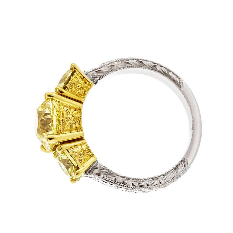 Fancy Intense Yellow Diamond Yellow Gold Platinum Three Stone Ring In Good Condition In Stamford, CT