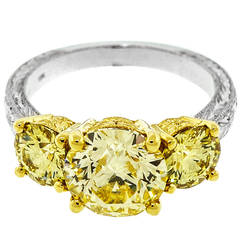 Antique Fancy Intense Yellow Diamond Yellow Gold Platinum Three Stone Ring