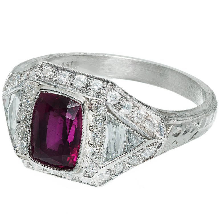 Cushion cut natural no heat red Ruby Art Deco cocktail ring with calibre cut trapezoid and triangle cut diamonds in a platinum setting. Circa 1930-1940.

1 cushion cut gem red Ruby, approx. total weight 1.33cts, SI1, 6.91 x 5.19 x 3.89mm, natural no
