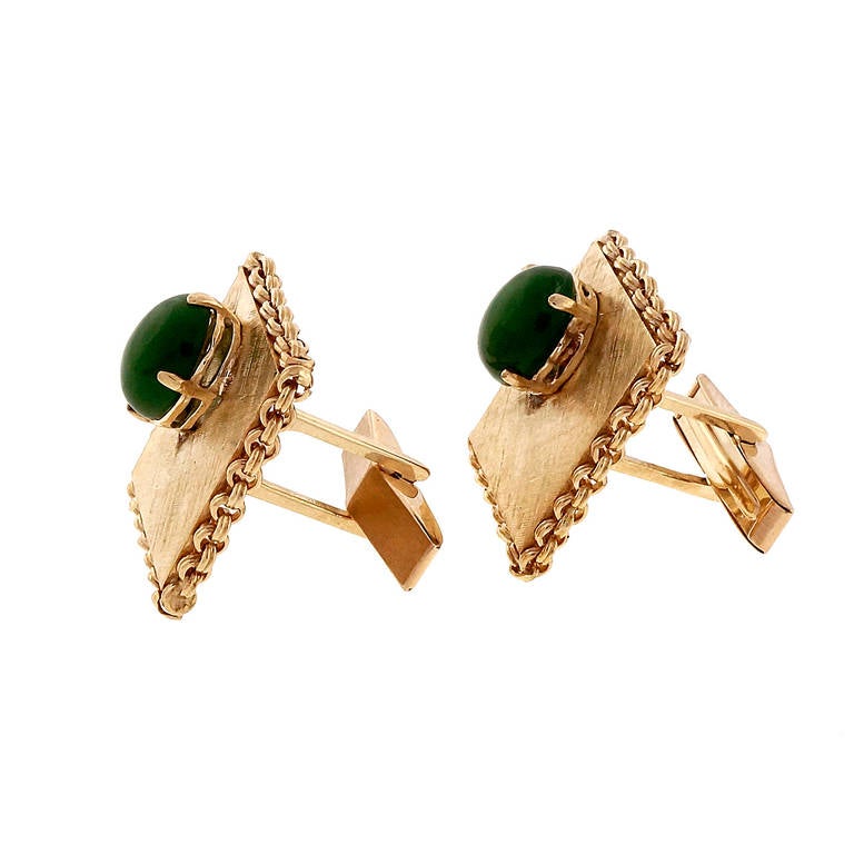 Mid-century 1950 handmade and hand textured cuff links with bright green natural untreated Nephrite Jade.

2 oval bright gem green Nephrite Jade, 10.05 x 8.30mm, translucent, GIA certificate #1162009606.
14k Yellow gold
17.1 grams
Stamped: