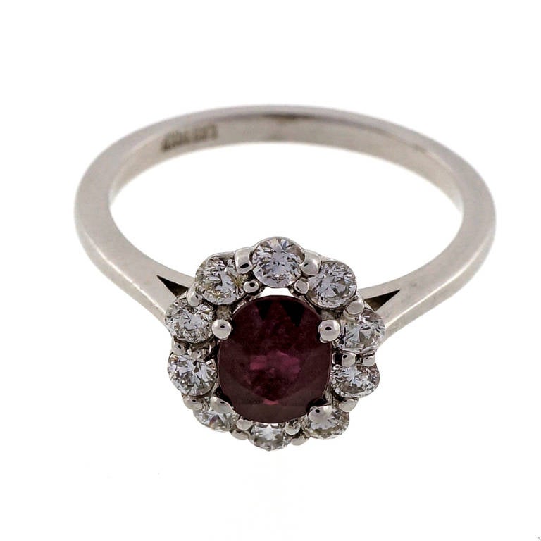 Rare top red Ruby 1.00ct oval. GIA certified natural corundum, simple heat with minor residue. Beautiful white gold cluster ring with nice full cut diamonds. Circa 1980.

14k White gold
1 oval top gem red Ruby, approx. total weight 1.00cts, SI1,