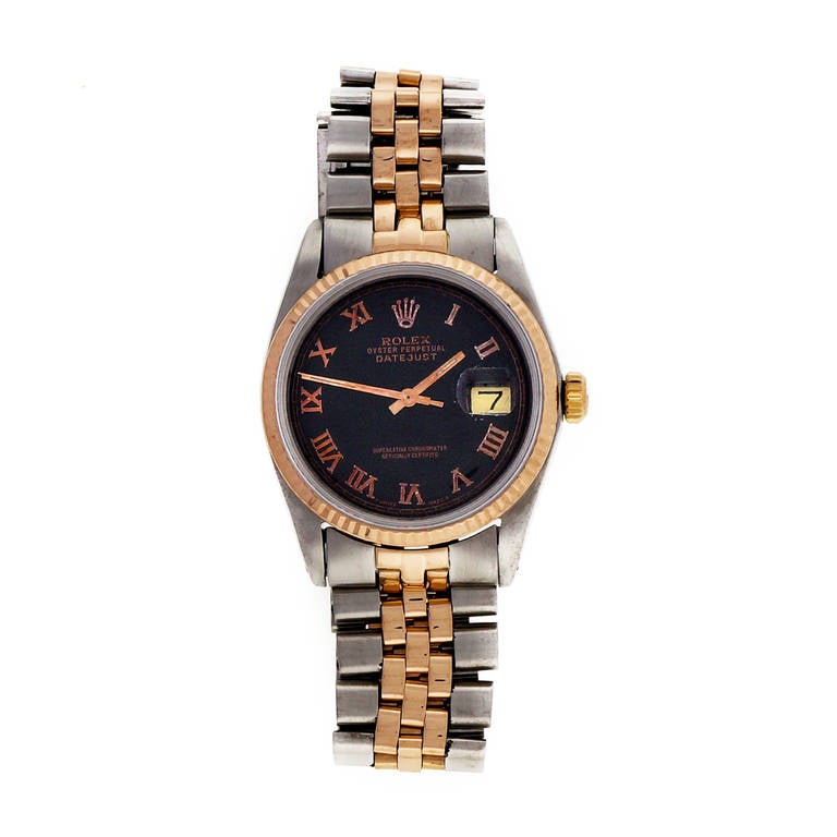 Rolex stainless steel and 14k rose gold Datejust wristwatch with Jubilee steel and rose gold bracelet. Black dial with rose gold Roman numerals, after-market sapphire crystal, non-quickset date. Rose gold bezel and crown. Circa 1972.

Stainless