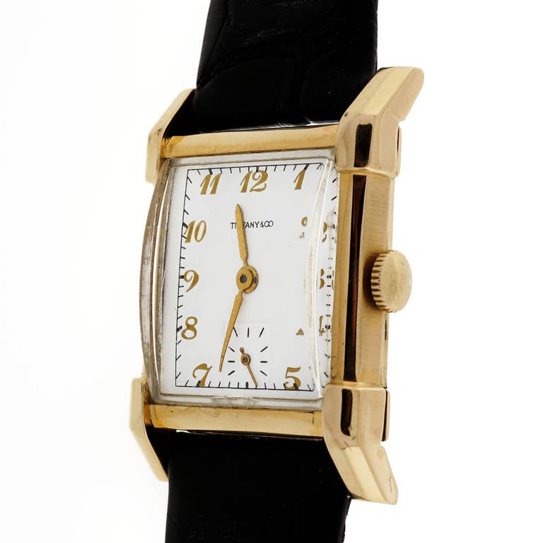Longines 14k yellow gold rectangular wristwatch, retailed by Tiffany & Co, circa 1947. With original domed crystal. Dial is an early refinish.

14k yellow gold
Length: 36.8mm
Width: 25mm
Bracelet width at case: 19mm
Case thickness: 9.7mm
Dial: