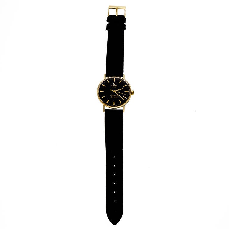 Omega 14k Yellow Gold Seamaster Wristwatch Retailed by Tiffany & Co, circa 1960s. One of the nicest Tiffany dials we have seen in shiny black. 

14k yellow gold
Length: 40.36mm
Width: 34mm
Strap width at case: 18mm
Case thickness: