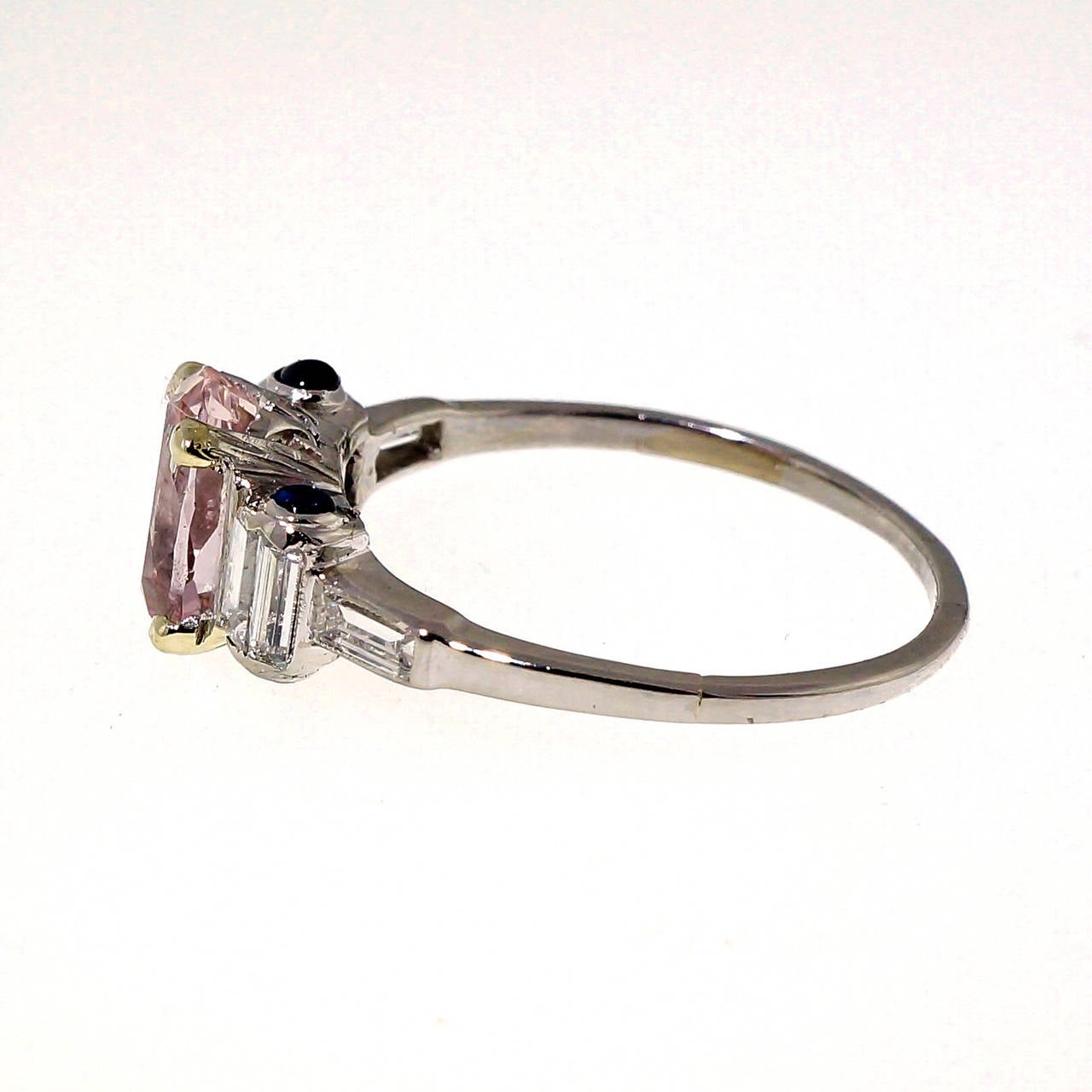 Original Art Deco one of a kind rare oval step cut light pink Sapphire in its original distinctive Art Deco ring with baguette shoulders. Circa 1910-1920. The top is in excellent condition. The shank is secure and shows a few seams from old well