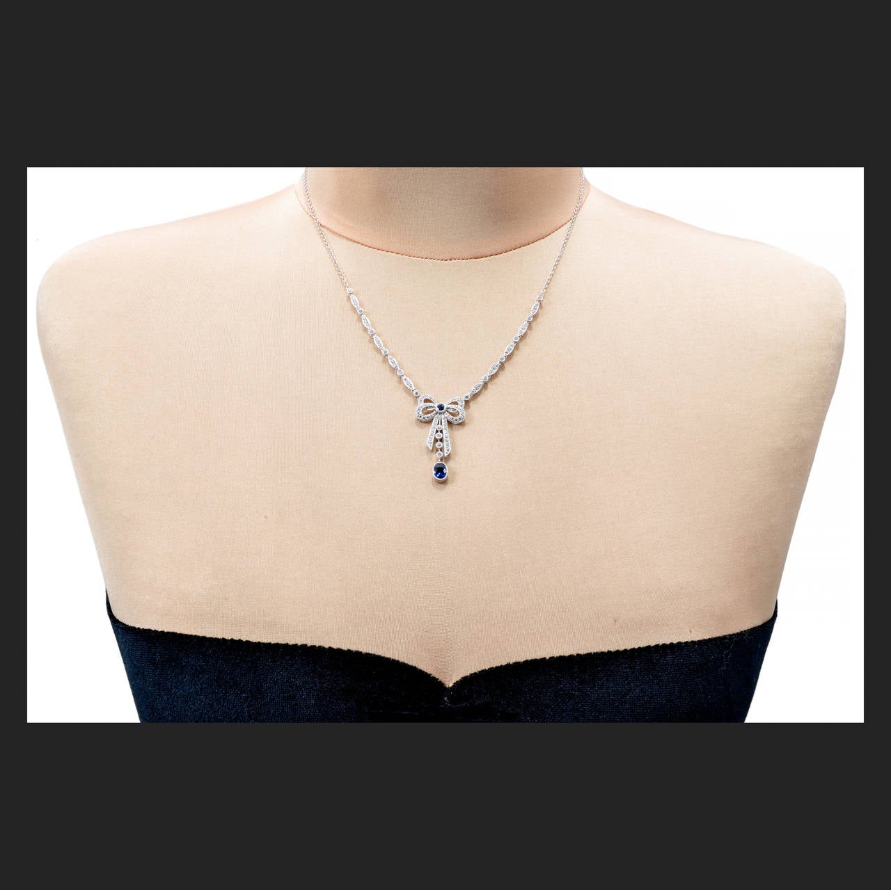 Oval Sapphire Pave Round Diamond Platinum Bow Pendant For Sale at 1stdibs