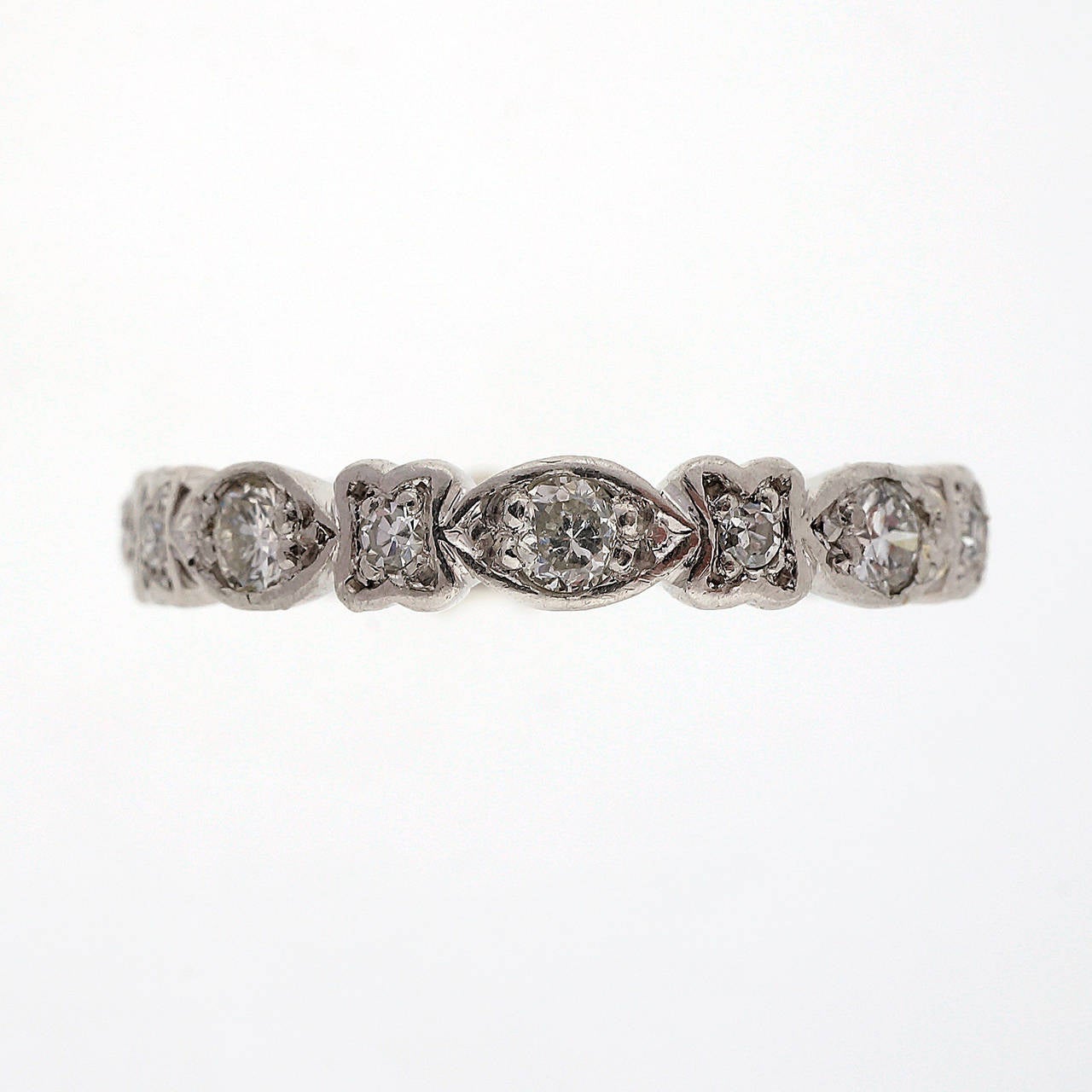 1930-1940 handmade Platinum Eternity ring set with bright white diamonds. an original style. Made for a size 8 hand.

18 full cut diamonds, approx. total weight .75cts, F, VS
Platinum
3.8 grams
Tested: Platinum
Stamped: Not
Width at