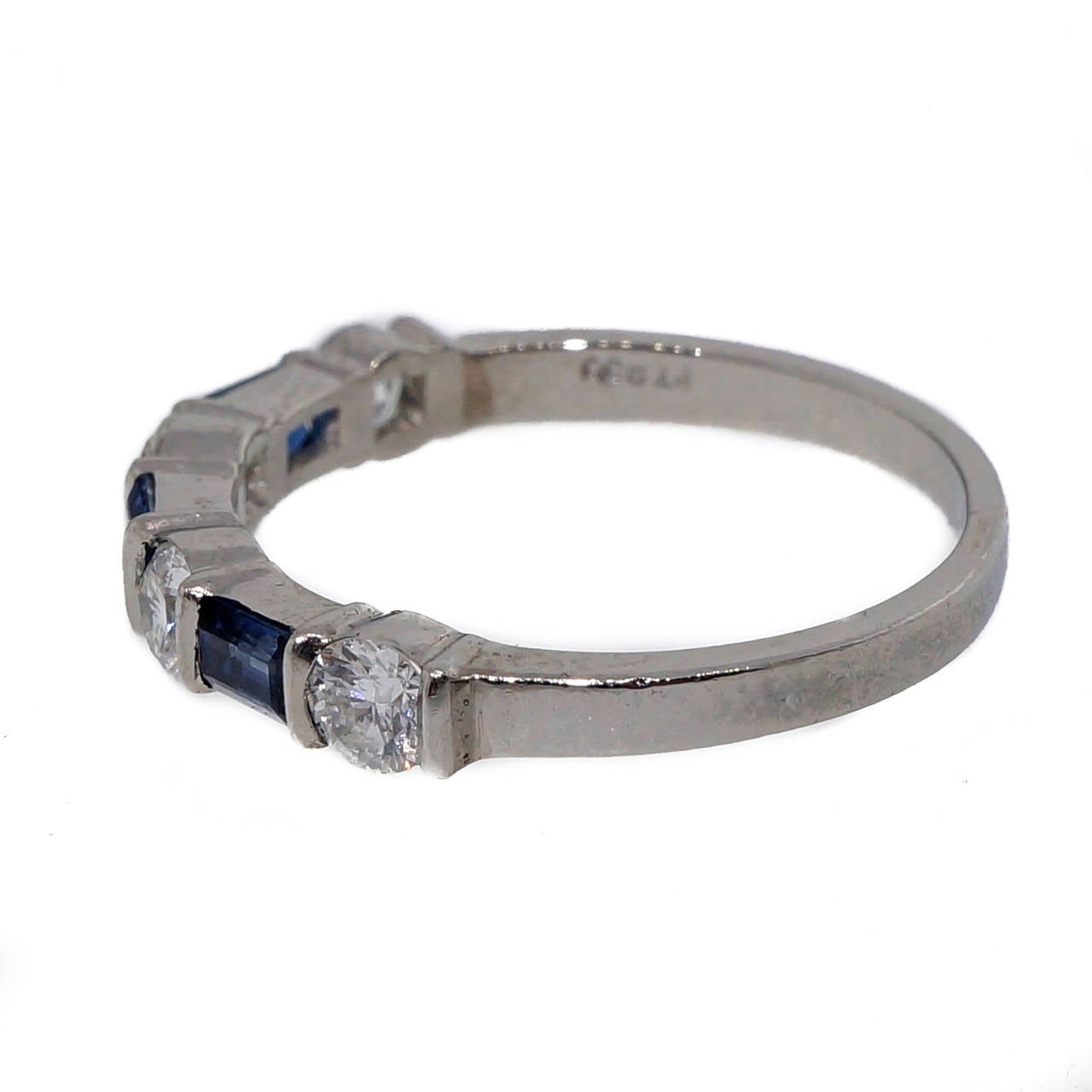 Authentic solid Platinum round diamond Sapphire baguette wedding band. Pre 2000 stamping. The T and I of Tiffany are worn off. Guaranteed authentic.

4 round Ideal cut full cut diamonds, approx. total weight .40cts, F, VS
3 blue Sapphire