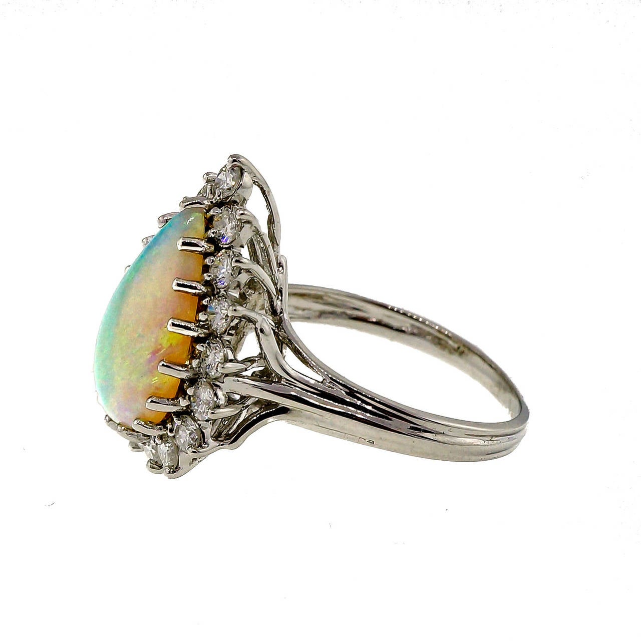 Beautiful classic 1950’s top quality well-polished Opal ring. Translucent blue green Opal with lots of orange flash surrounded by nice full cut diamonds. The orange is so bright it looks like an orange flash light in the stone.

1 blue green