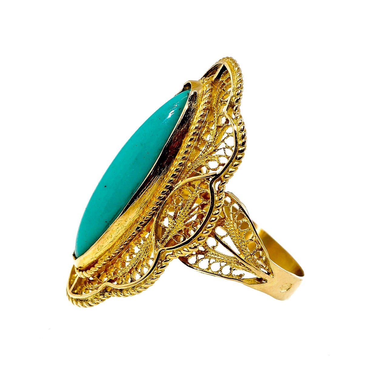 Totally handmade open filigree work ring, rare and unusual in today’s world, set with a fire well-polished Persian untreated Turquoise. Circa 1940 to 1950.

1 Marquise blue Persian Turquoise, 12 x 7mm
18k yellow gold
6.7 grams
Tested: