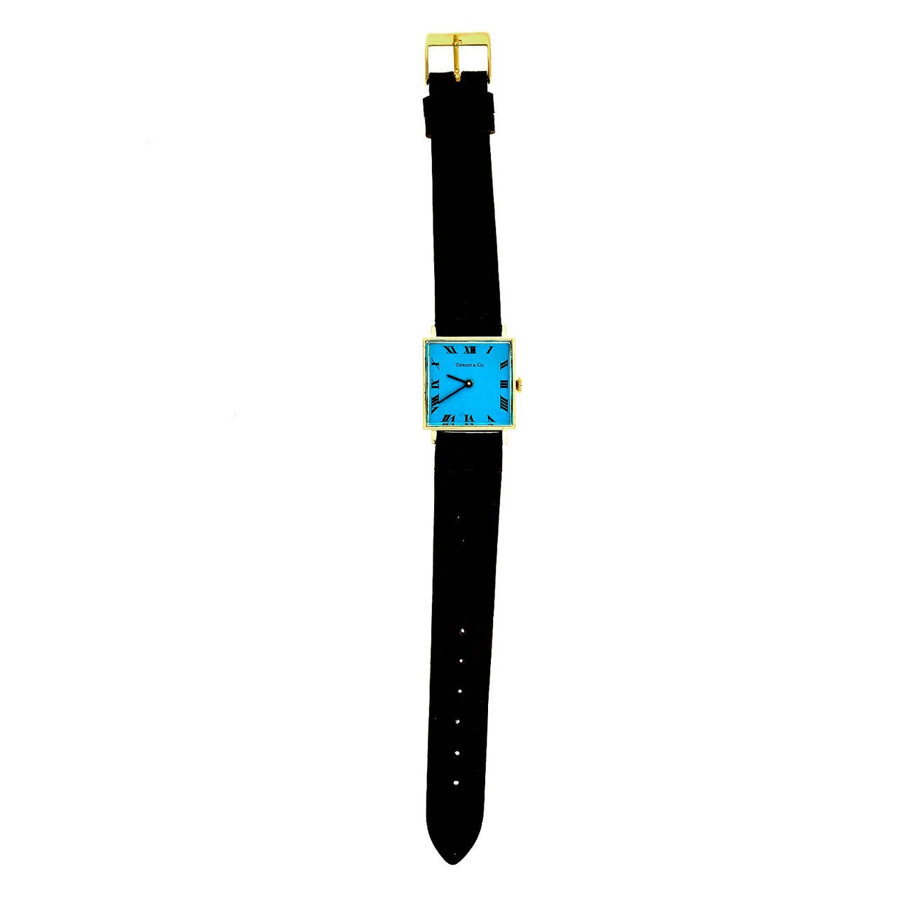 Tiffany & Co 14k yellow gold square wristwatch with custom-colored dial and manual-wind movement, circa 1960s.

14k yellow gold 
Length: 32.59mm 
Width: 25.32mm
Case thickness: 7.6mm 
Strap width at case: 18mm 
Dial: refinished
