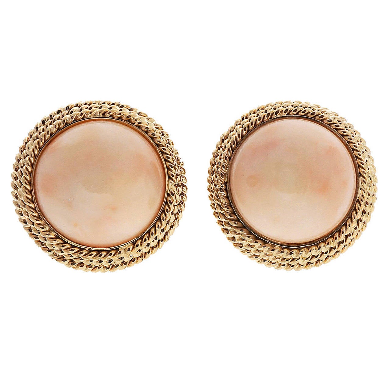 Vintage 1950-1960 well polished light pink natural Coral, not dyed or treated. Handmade 3 row twisted wire frames. Omega clip and post back.

2 natural light pink round Coral, untreated and well-polished, 17.3mm
14k Yellow gold
18.9 grams
Tested:
