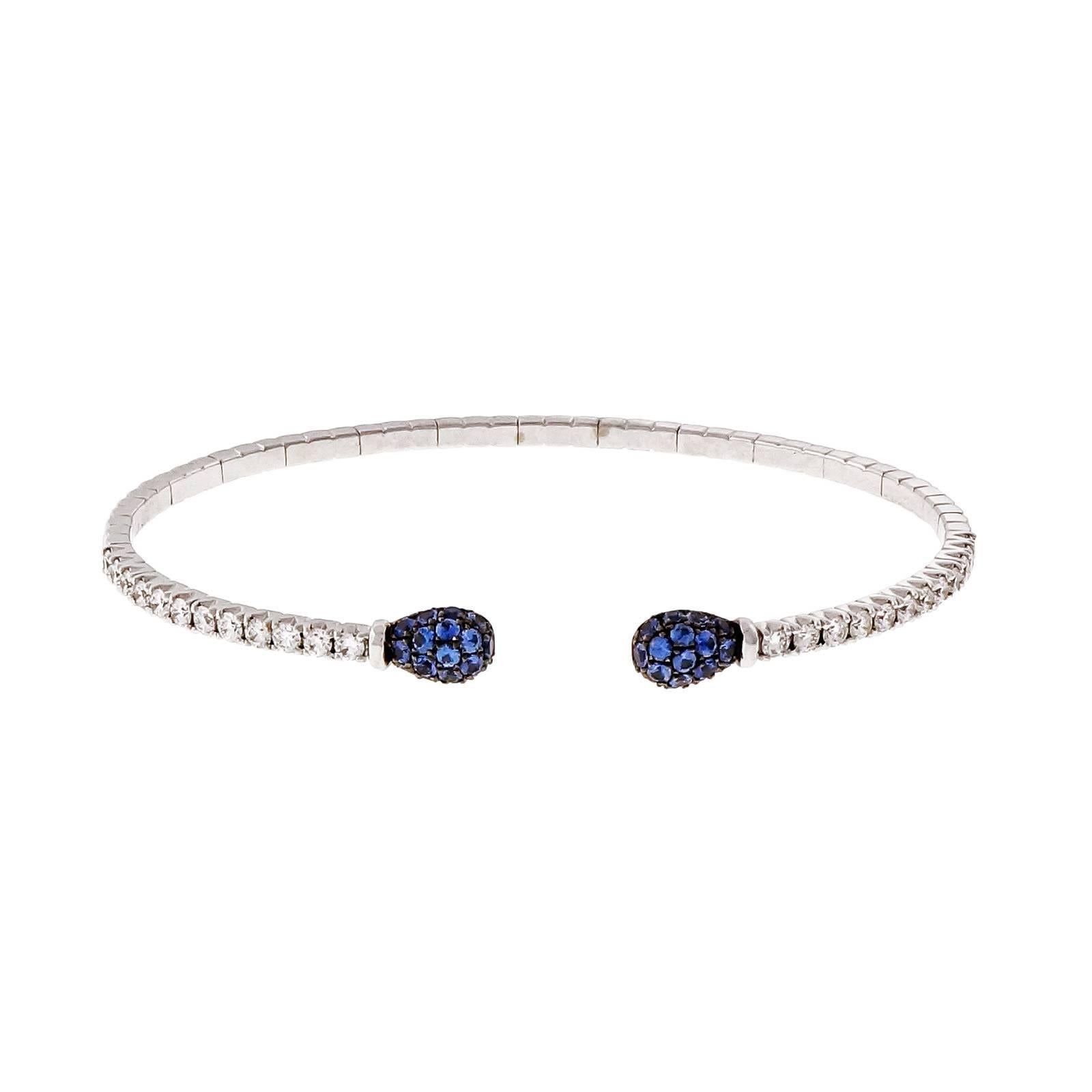 Designer Spark 18k white gold cuff bangle bracelet with blue Sapphires and fine white diamonds.

34 round sapphires, approx. total weight .96cts
24 round diamonds approx. total weight .50cts
18k white gold
Tested and stamped: 18k
Hallmark: