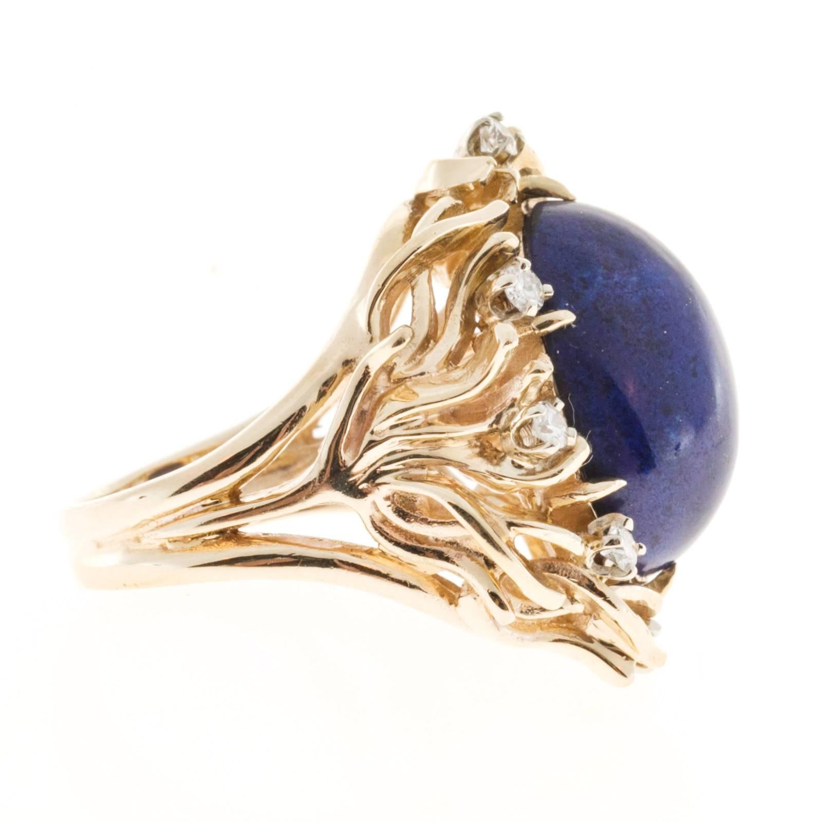 1950’s open work solid 14k yellow gold ring with high grade full cut diamonds surrounding a bright well-polished rare certified violet blue Lapis with no enhancements. Top gem color.

1 oval violet blue cabochon Lapis, 18.02 x 12.94 x 7.22mm,