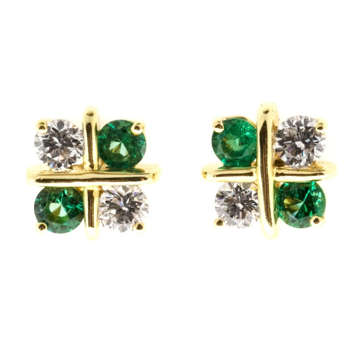 “X” style 18k yellow gold fine diamond Emerald earrings. Green genuine Emeralds. High grade diamonds.

4 round diamonds, approx. total weight .40cts, F, VS
4 round Emeralds, 3mm, VS, top gem
18k yellow gold
Tested: 18k
Stamped: 750
3.4