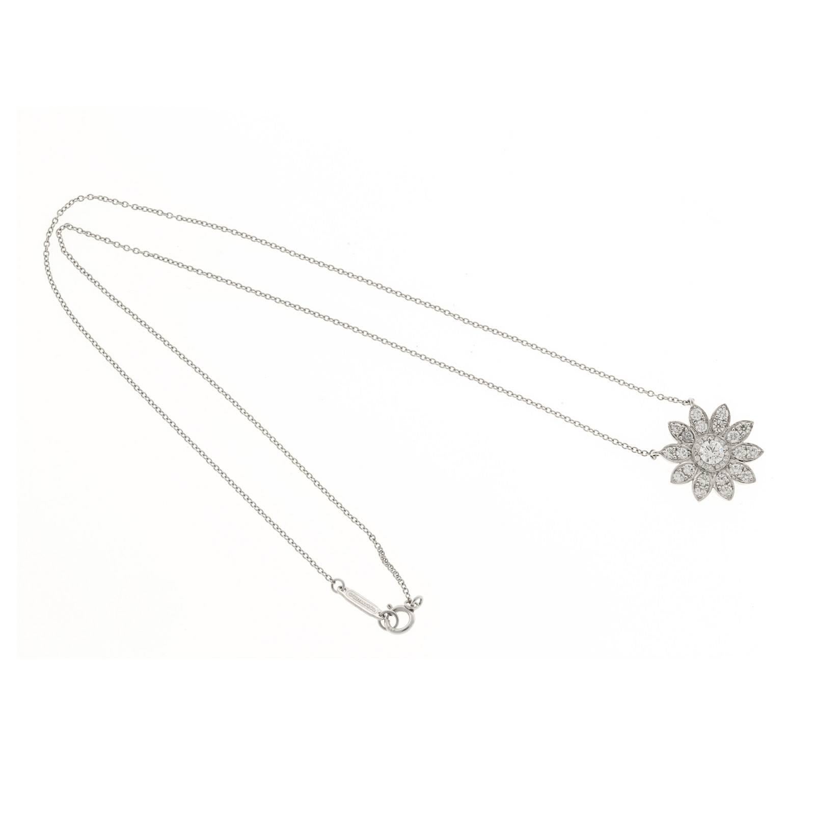 Tiffany & Co sunflower Platinum diamond necklace. Center diamond is surrounded by a circle of small full cut diamonds and diamond set flower petal.

1 round diamond, approx. total weight .18cts, F, VS
35 round diamonds, approx. total weight