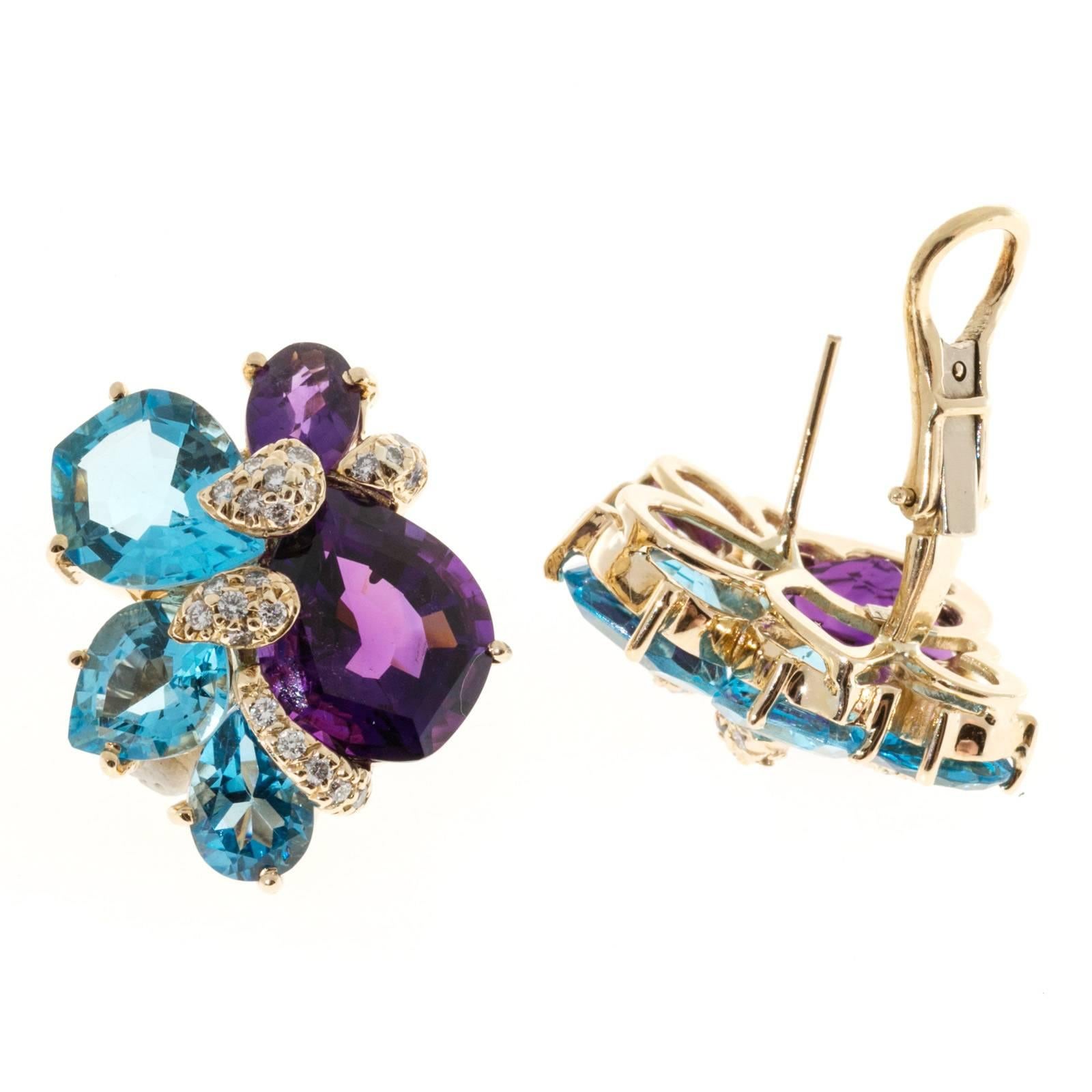 Wendee & Rene 18k yellow gold clip post earrings. Vivid bright blue Topaz and vivid purple Amethyst. Clip and post style. Pave diamonds.

2 fancy cut Amethyst, approx. total weight 6.00cts, 13.23 x 10.61 x 7.05mm
44 round diamonds, approx. total