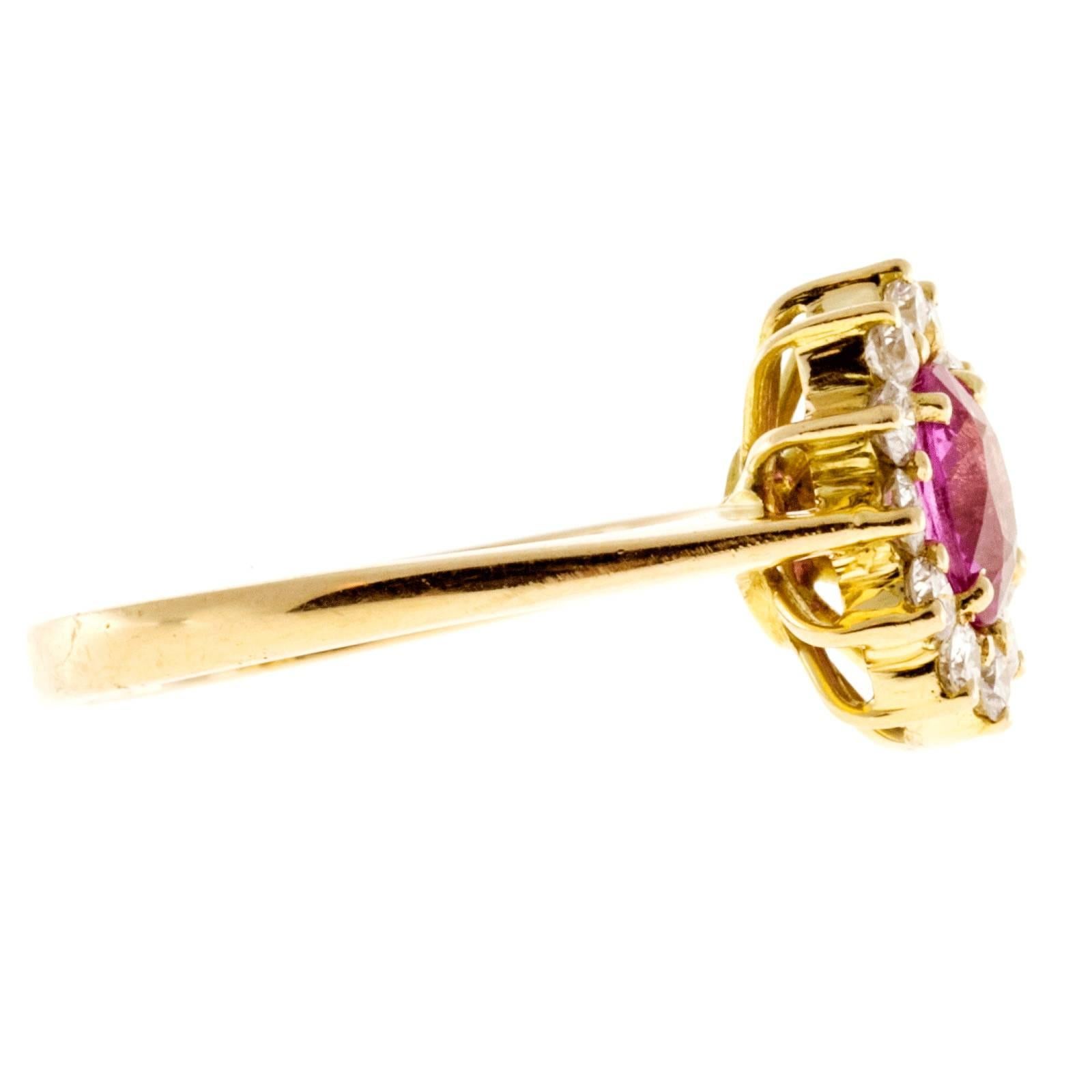 Vintage 1960 GIA certified natural no heat fine gem pink Sapphire surrounded by very bright full cut white diamond halo in a 18k yellow gold setting.

1 oval bright pink Sapphire, approx. total weight .75cts, VS2, 6.98 x 5.26 x 3.35mm, GIA