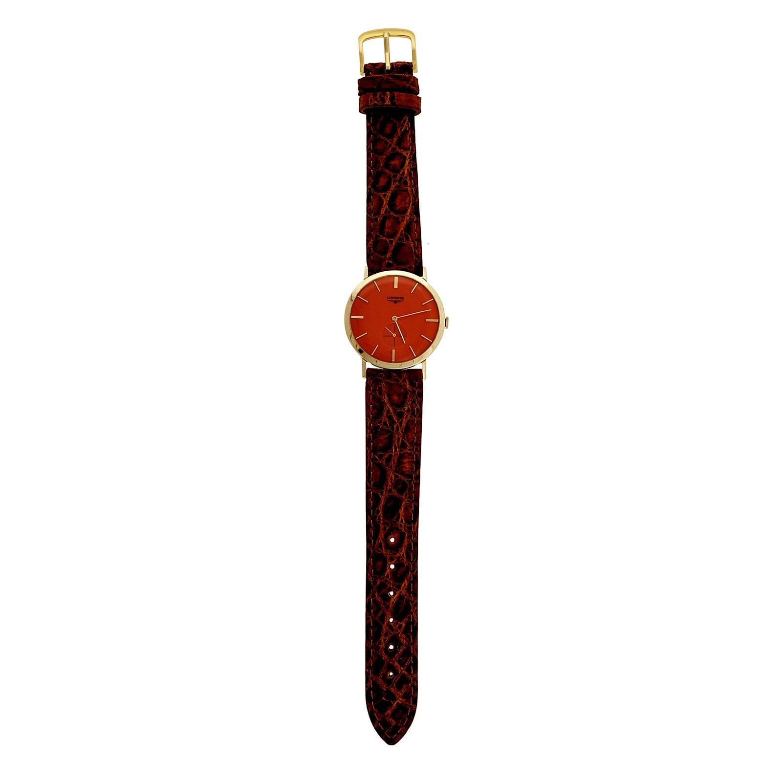 1960’s Longines manual wind wrist watch in a simple classic case with Longines dial refinished in a custom Peter Suchy process by multiple layers of bright high luster vivid orange finish.

14k yellow gold
25.7 grams
Lug tip to ring: